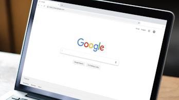 image shows the google search engine page on a laptop screen