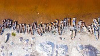 Photo Showing Aerial View Of The Small Boats For Salt Collecting At Pink Lake Retba Senegal Shutterstock 1570960909