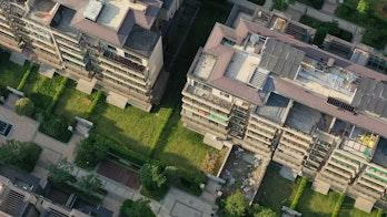 Photo depicts Aerial top view of modern European townhouse buildings in China